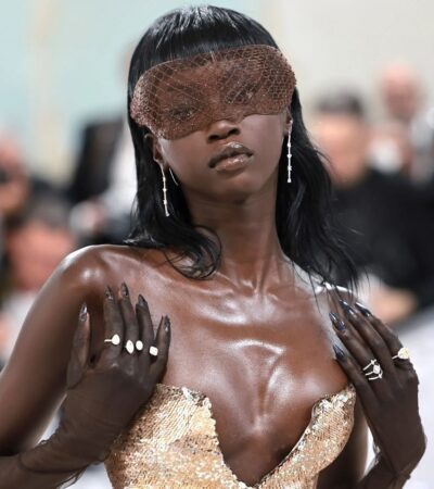 Anok Yai in elegant gown with striking accessories.