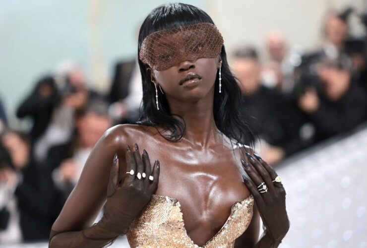 Anok Yai in elegant gown with striking accessories.