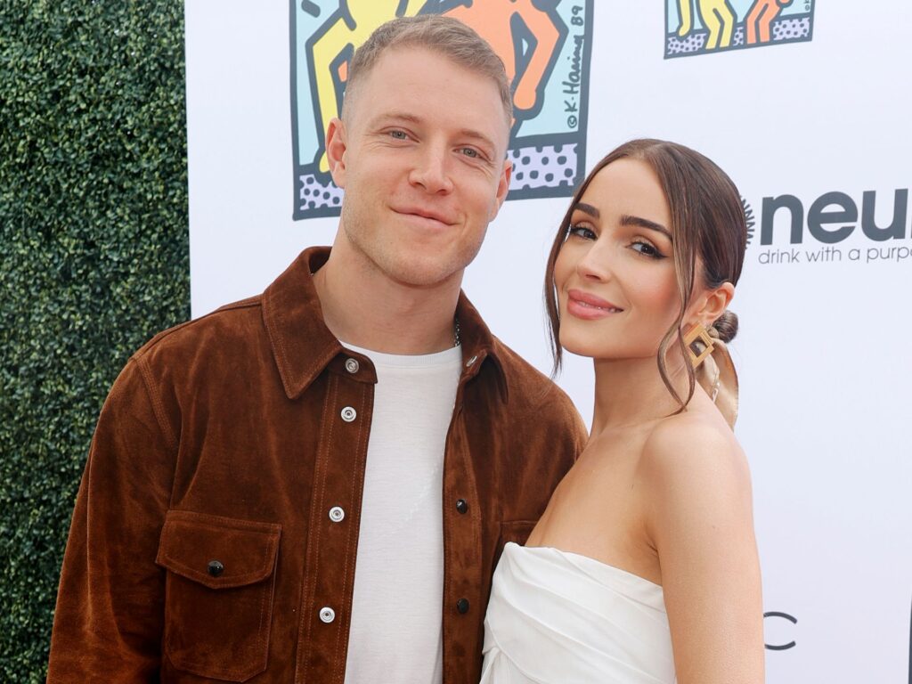 Christian McCaffrey and Olivia Culpo attend an event